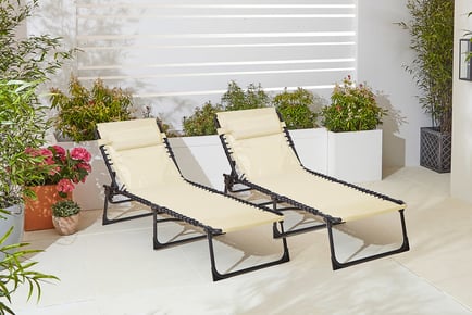 CREAM: A pair of outdoor sun loungers