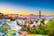 View of mosaic tile and Barcelona cityscape in park Guell at sunset | Spain