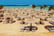 Chaise lounge and parasols on the beach against the blue sky and sea. Egypt, Hurghada
