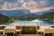 View of set up on patio of restaurant overlooking Lake Bled, Slovenia; Alps and sky with clouds in background