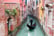 Venetian gondolier punting gondola through green canal waters of Venice Italy