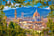 Florence rooftops and cathedral di Santa Maria del Fiore or Duomo view through leaves frame