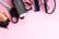 Scissors and other hairdressing tools on a pink background