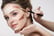 Makeup artist contouring a woman's cheek