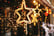 Stylish christmas golden star illumination and fir branches with red and gold baubles,