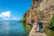 Ohrid, Macedonia - June 1st 2018 - Couple walking in a narrow wood path in front of a steep cliff in the edge of the amazing blue Ohrid lake