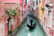 Venetian gondolier punting gondola through green canal waters of Venice Italy