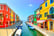 Venice landmark, Burano island canal, colorful houses and boats