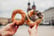 Couple of tourists holding bagels obwarzanek traditional polish cuisine snack on Market square in Krakow. Travel Europe