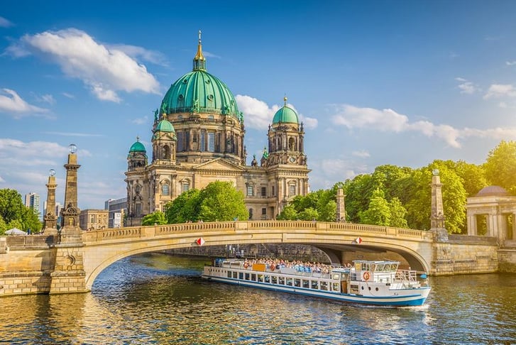 Berlin Cathedral with ship on Spree river-at-sunset,-Berlin, Germany
