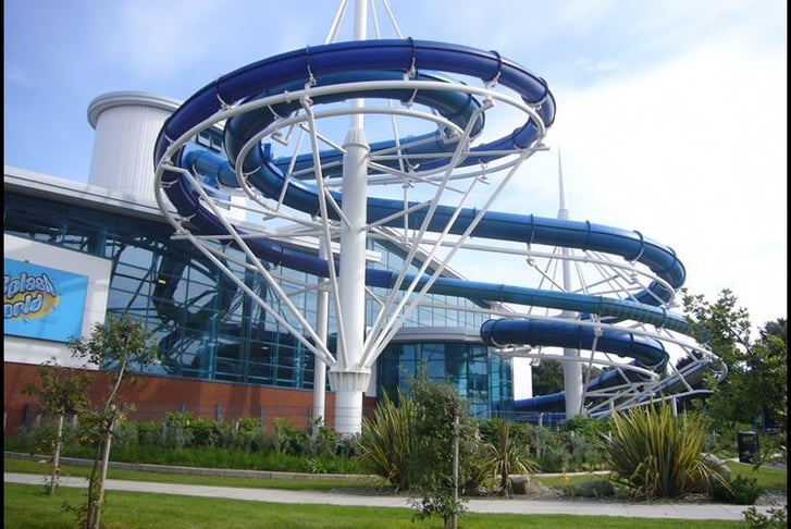 A blue water slide on the outside of Splash World Water Park