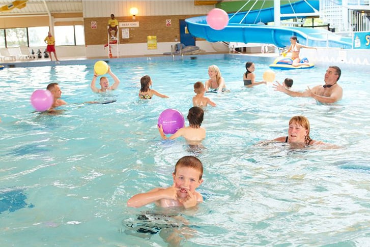 Kids and parents enjoying a swimming pool at  