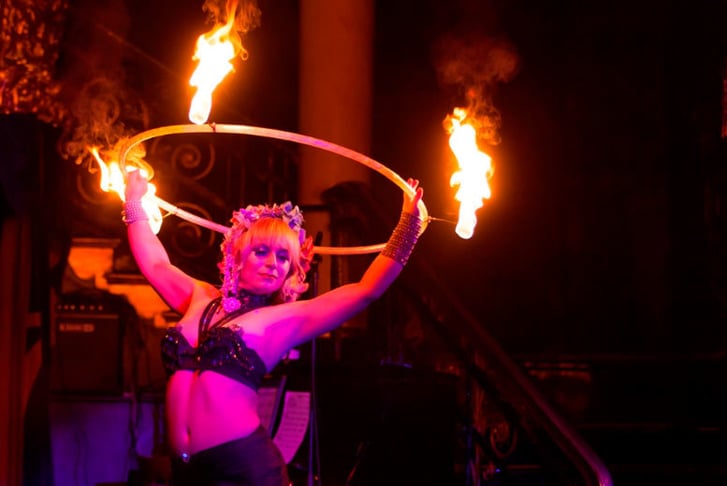 A cabaret dancer performing with a ring of fire