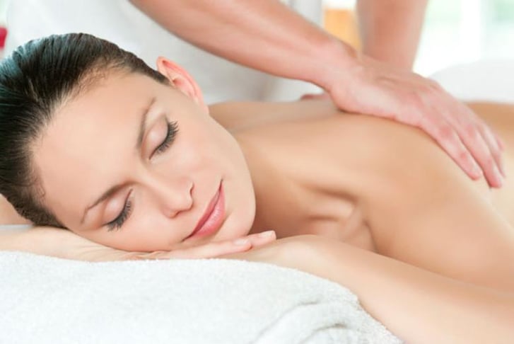 A woman receiving a back massage