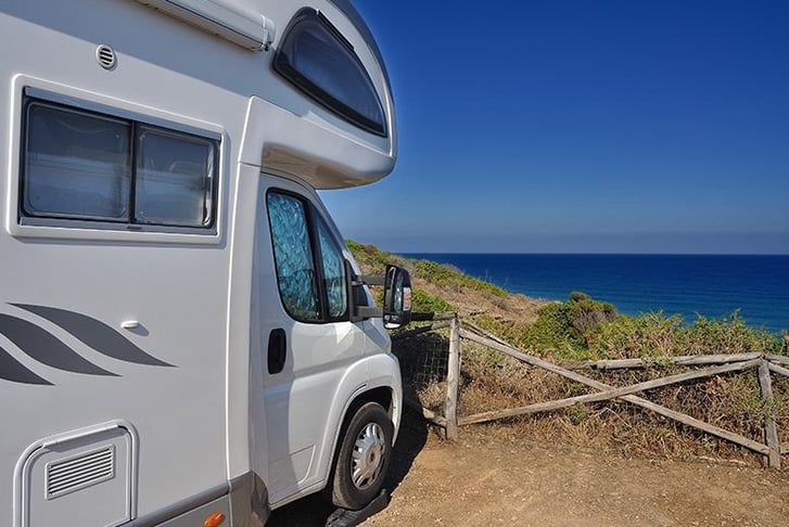 A motorhome parked near the coast with a sea-view 