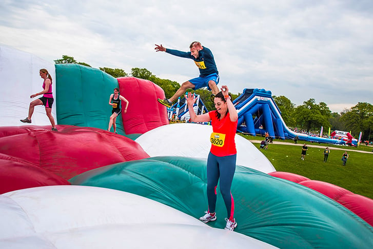 People bouncing on a giant inflatable