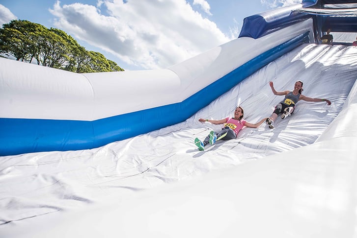 People sliding down a giant inflatable slide