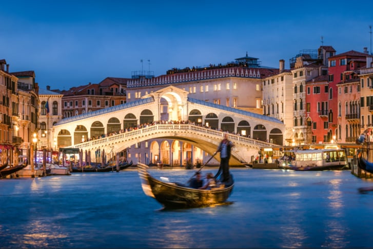 Romantic gondola ride near Rialto Bridge in Venice, Italy