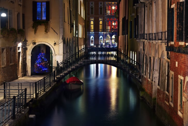 Typical Venetian canal with bridge and Illuminated Christmas tree, night view, Venice, Italy