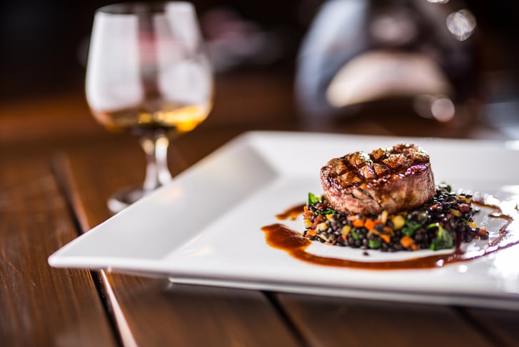 Ribeye Steak Dining with a Bottle of Wine
