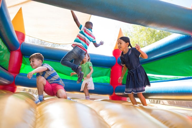 Kids playing on a bouncy castle