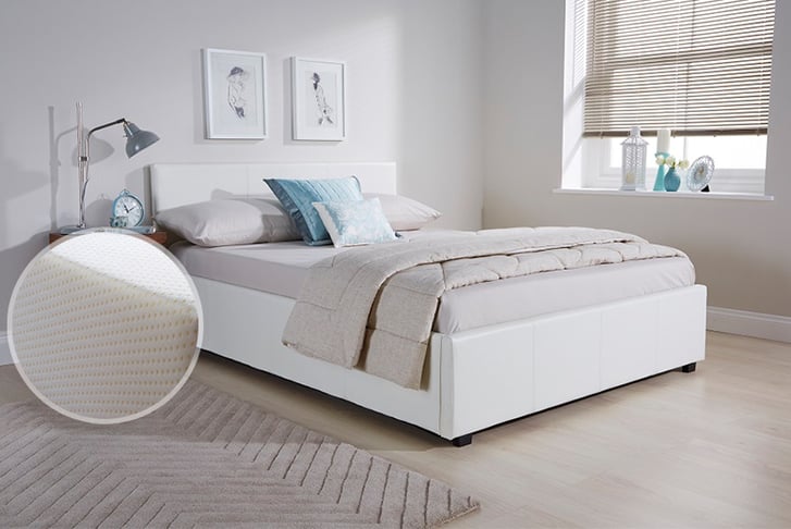 A white faux leather bed neatly made