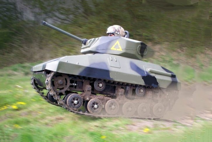 Someone driving a Mini Tank across a field