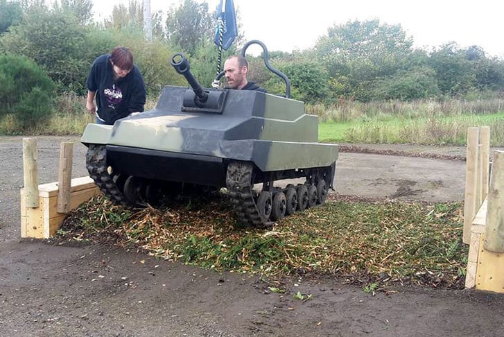 A man going over a bump in a Mini Tank