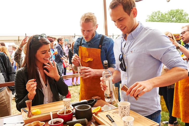 A couple being served gin at Taste of London festiival