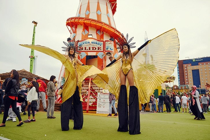 Two performers at the Urban Beach Festival stood on stilts