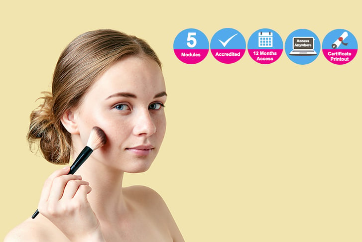 Woman holding makeup brush against yellow backdrop