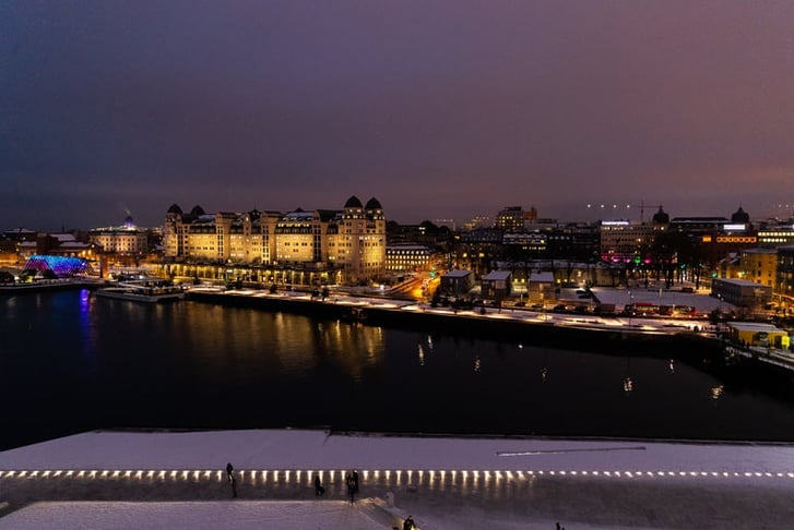 Overlooking the city center of Oslo Norway during the winter all covered with fresh snow during the evening time